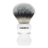 A clear synthetic shaving brush with a black and white bristle-like tuft, labeled 'GOODFELLAS' SMILE'.