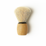 Shaving brush with wooden handle and bristle head on a white background