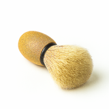 Shaving brush with bristle head and wooden handle on a white background