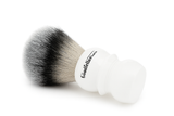 Shaving brush with black and white bristles on a white background