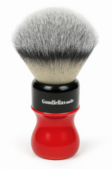 Shaving brush with red handle and black ferrule on a white background
