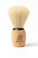 Shaving brush with wooden handle and black bristles on a white background