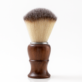 Shaving brush with wooden handle and synthetic bristles on a white background