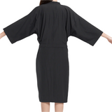 Black kimono-style dress worn by a person on a white background