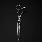 A professional Damascus pattern hairdressing scissors with a black and silver color scheme, featuring intricate engravings on the handle.