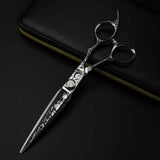 A professional Damascus pattern hairdressing scissors with a black and silver color scheme, featuring intricate engravings on the handle.