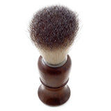 A barber shaving brush with a wooden handle and badger hair bristles.