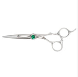 A pair of silver-colored hairdressing scissors with a green crystal on the handle, designed for professional use.