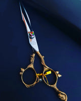 A pair of professional hairdressing scissors with a polished silver finish, featuring convex edge blades and a fixed finger rest.