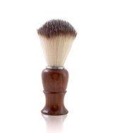 A barber shaving brush with a wooden handle and badger hair bristles.