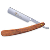 A professional single blade straight razor with a wooden handle and a plastic guard.